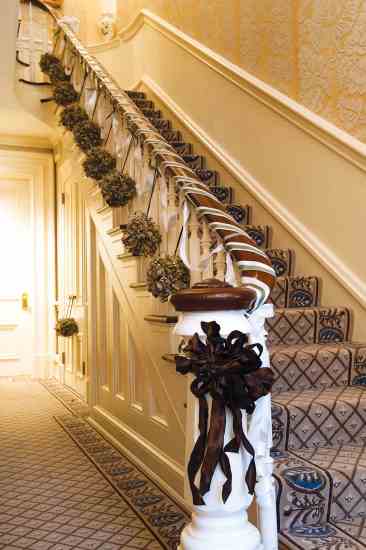 Ten Thousand Villages' dried flower mistletoe balls—handmade in Peru from eucalyptus, wheat, caspia and salal—grace the Blair House Jackson Entry staircase.